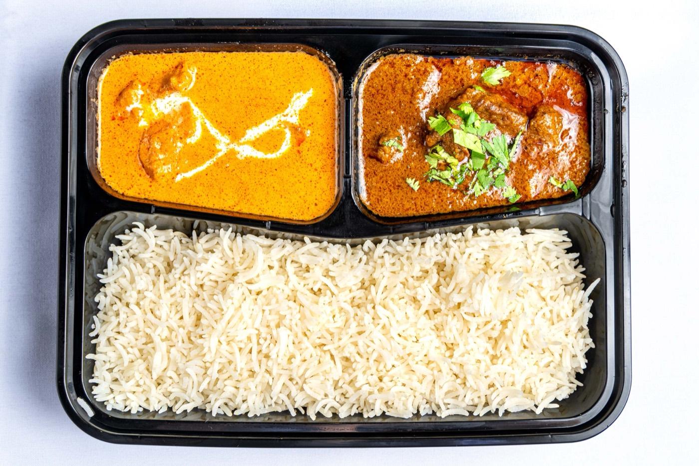Butter chicken and goat curry with basmati rice, catered by India 101 in Irving, TX
