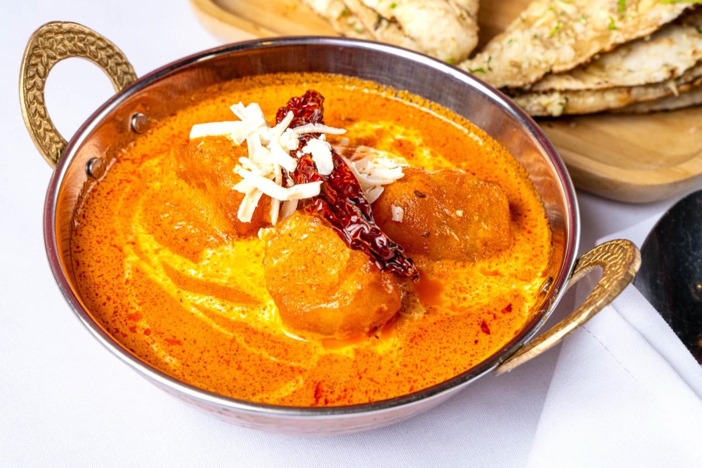 Chicken tikka masala in a creamy tomato gravy served in a copper karahi at India 101