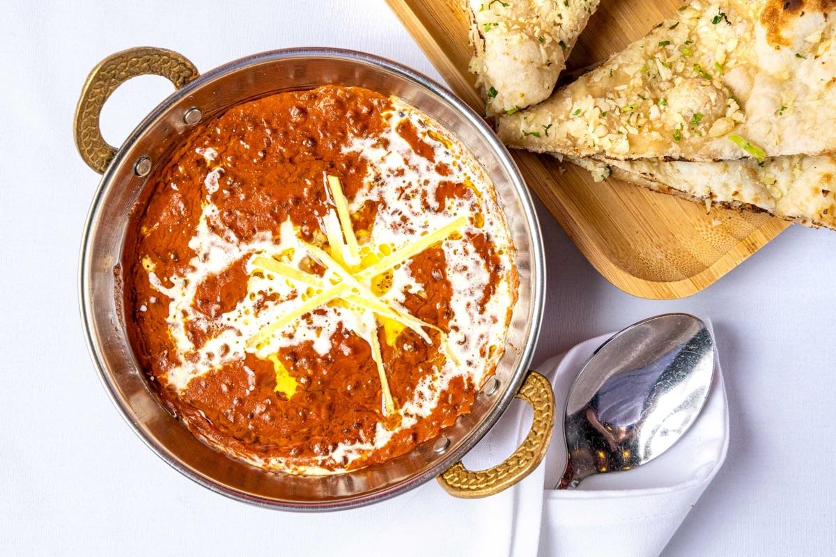 Dal makhani — creamy black lentils in a buttery tomato gravy with garlic naan